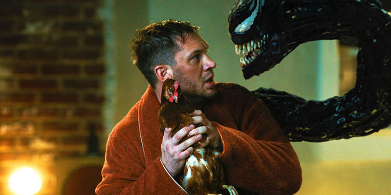 Tom Hardy's Eddie Brock with a chicken speaking to Venom in Venom