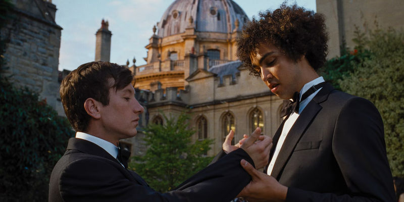 Oliver Quick (Barry Keoghan) showing the sleeves of his tuxedo to Farleigh Start (Archie Madekwe) in Saltburn. - Saltburn's Unforeseen Triumph Unveiled
