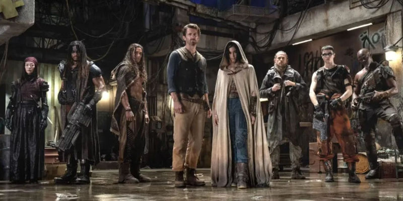 The cast of Rebel Moon: Part One - A Child of Fire in line in a promo image.