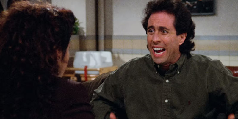Jerry smiling but looking concerned at Elaine in Seinfeld