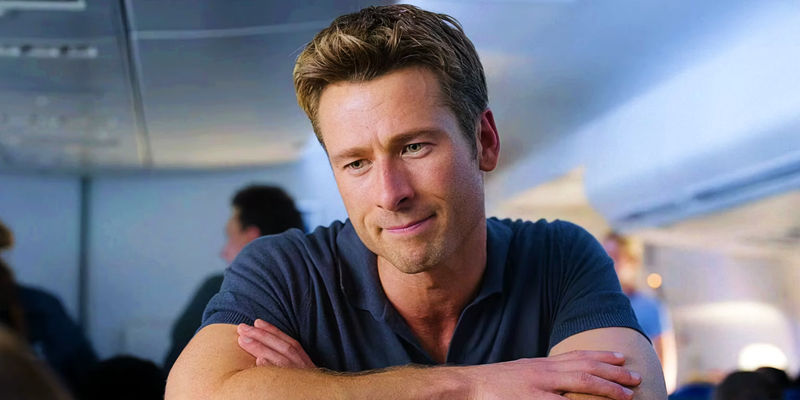 Glen Powell as Ben resting hands on airplane headrest in Anyone but You