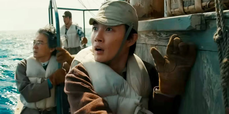 Ryunosuke Kamiki as Kōichi Shikishima and Hidetaka Yoshioka as Kenji Noda Look Shocked on a Boat in Godzilla Minus One