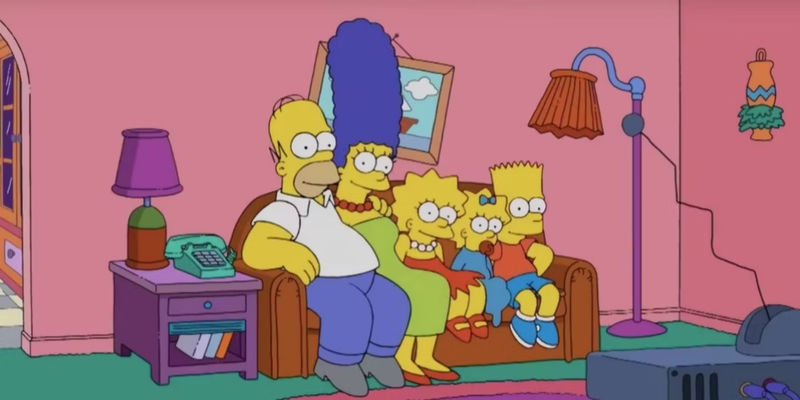 The Simpsons sitting on their couch in the opening sequences of The Simpsons.