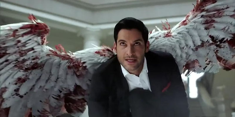 Tom Ellis in the TV Show Lucifer with his boodied wings spread
