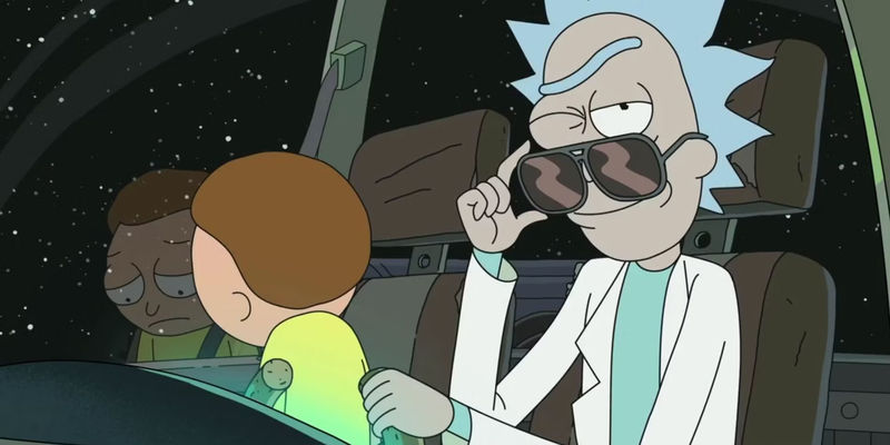 Rick winks at the camera as Morty looks dejected in a spaceship in Rick and Morty