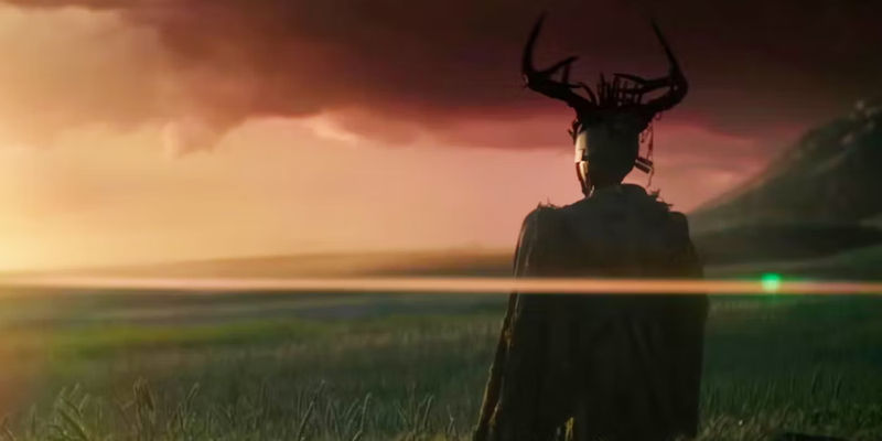 A character with antlers looking out over a grassy plain in Rebel Moon.