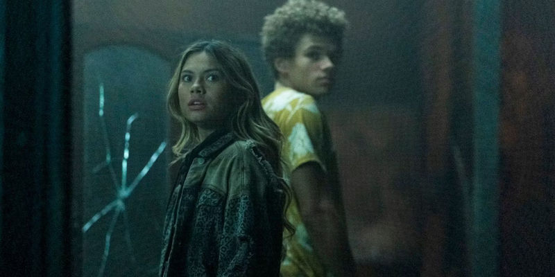 A boy and a girl standing with their backs turned on each other in Wolf Pack