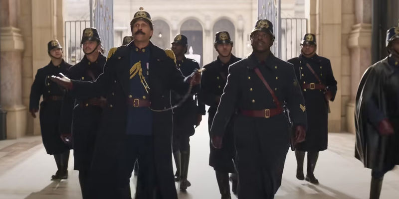 Keegan-Michael Key as the Chief of Police with his officers in Wonka