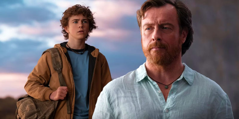 Percy Jackson standing on a beach next to Toby Stephens as Poseidon from the Disney+ SHow