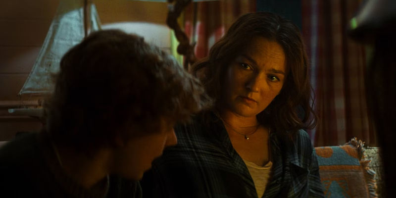 Sally looks over at Percy while sitting in the cabin in Montauk in Percy Jackson & the Olympians.