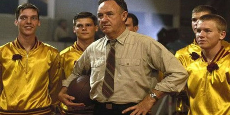 Coach Norman (Gene Hackman) stands alongside his team in Hoosiers