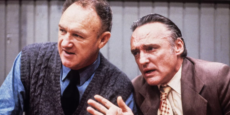 Coach Dale (Gene Hackman) and Shooter (Dennis Hopper) discuss tactics in Hoosiers
