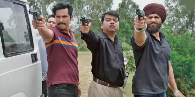 Three men in a line pointing guns together in Inspector Avinash.