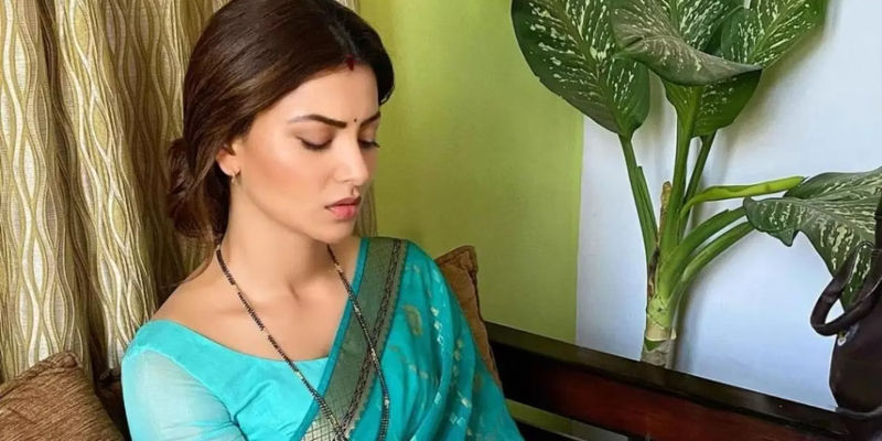 Urvashi Rautela as Poonam Mishra sitting and looking downcast in Inspector Avinash.