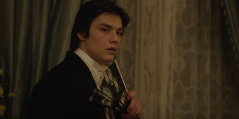 Lord Tewkesbury (Louis Partridge) holding a fan and looking besotted in Enola Holmes