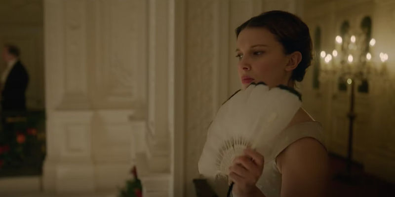 Enola Holmes (Millie Bobby Brown) fanning herself