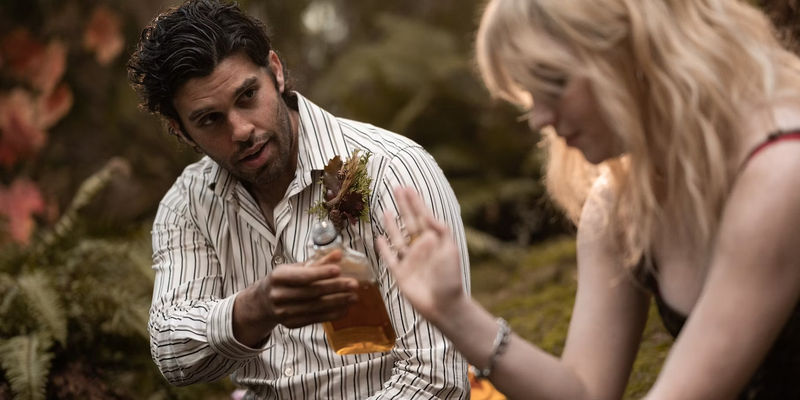 Coach Ben (Steven Krueger) shares a drink with Natalie in yellowjackets