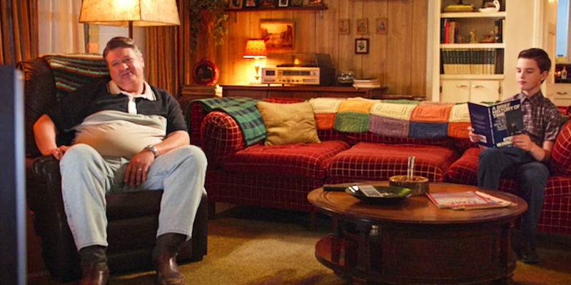 George watches TV while Sheldon reads on Young Sheldon