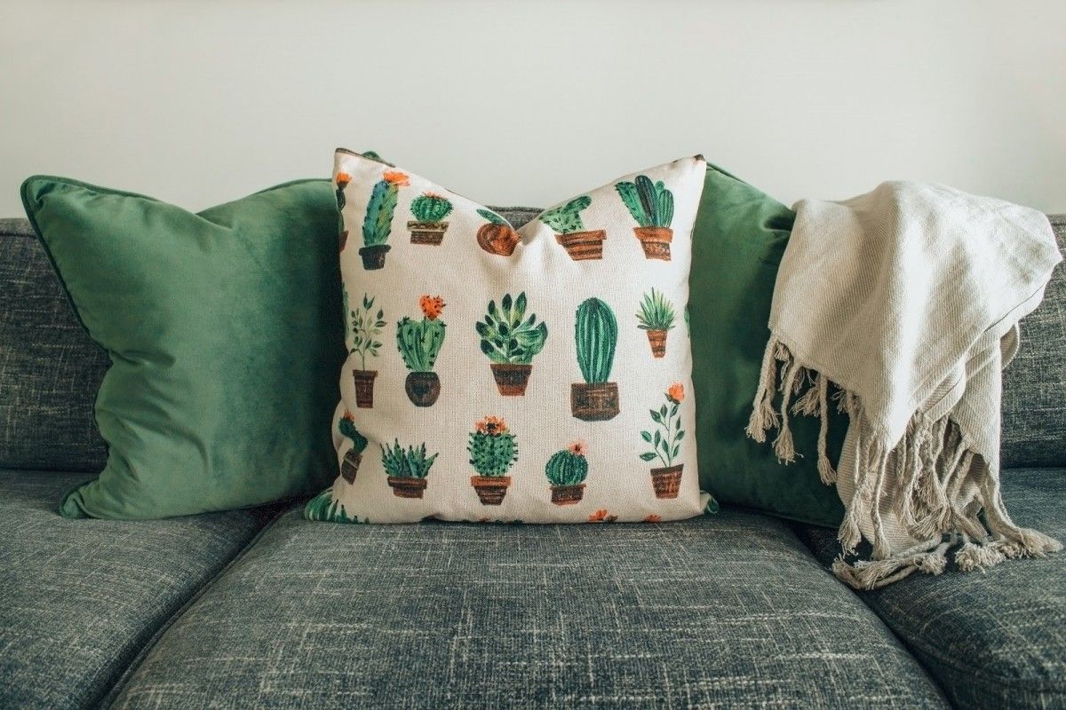 green sofa with cushions on