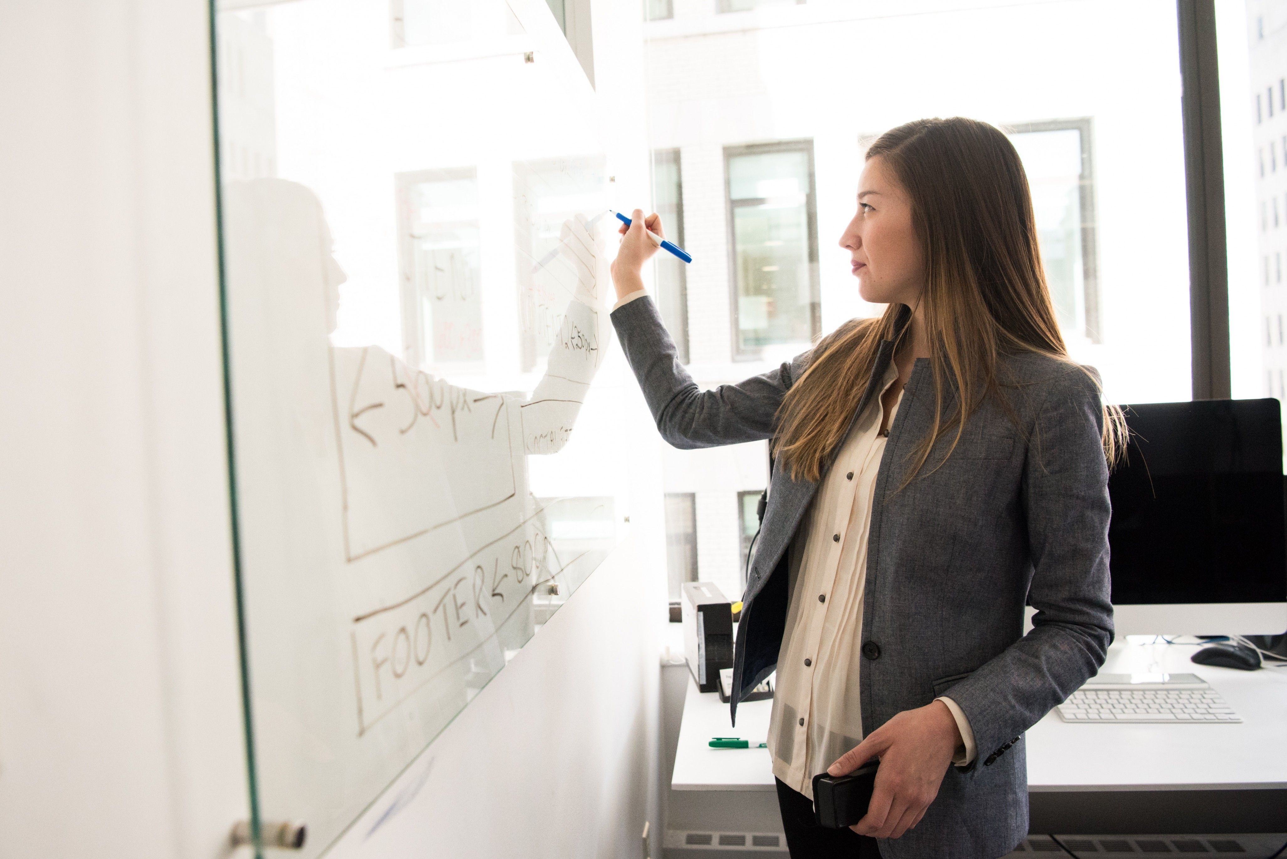 A lady writing on a board