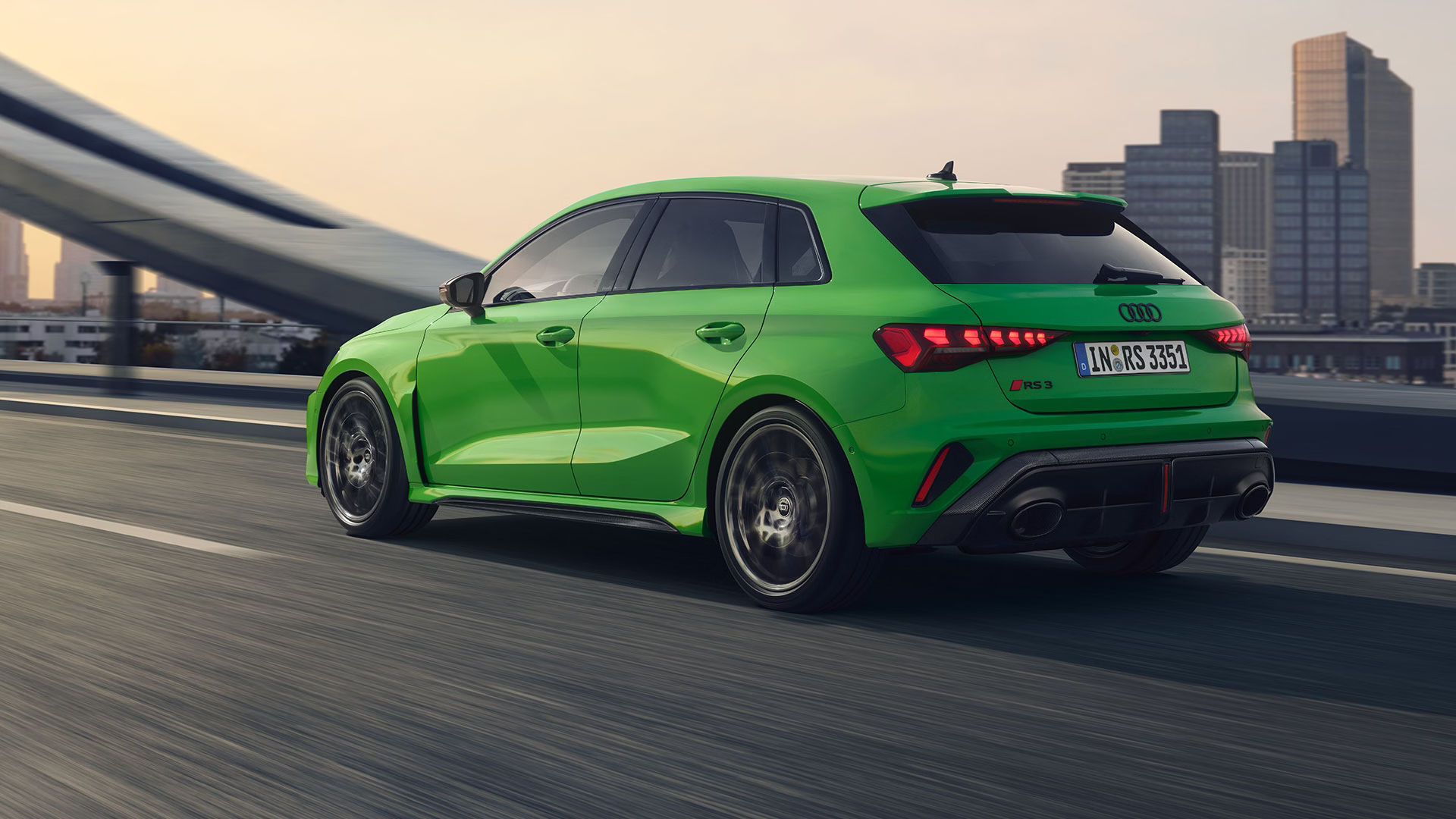 Audi RS 3 in green driving away