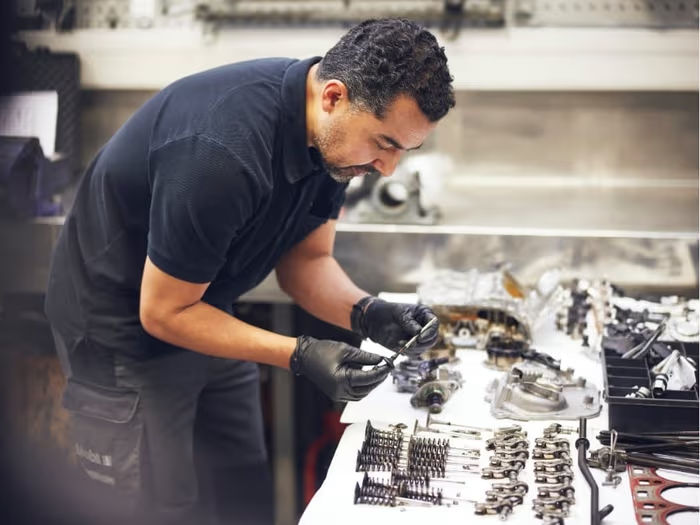 Porsche technician holding porshce classic parts