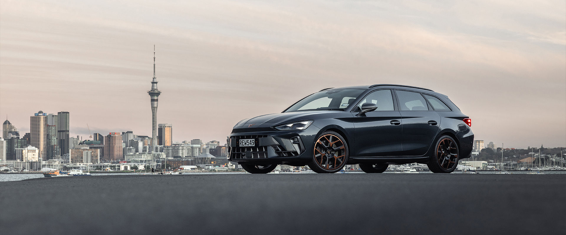 Cupra Leon Sportstourer against Auckland skyline