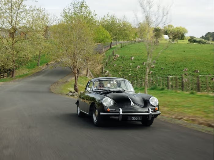 Classsic Black Porsche driving on a road