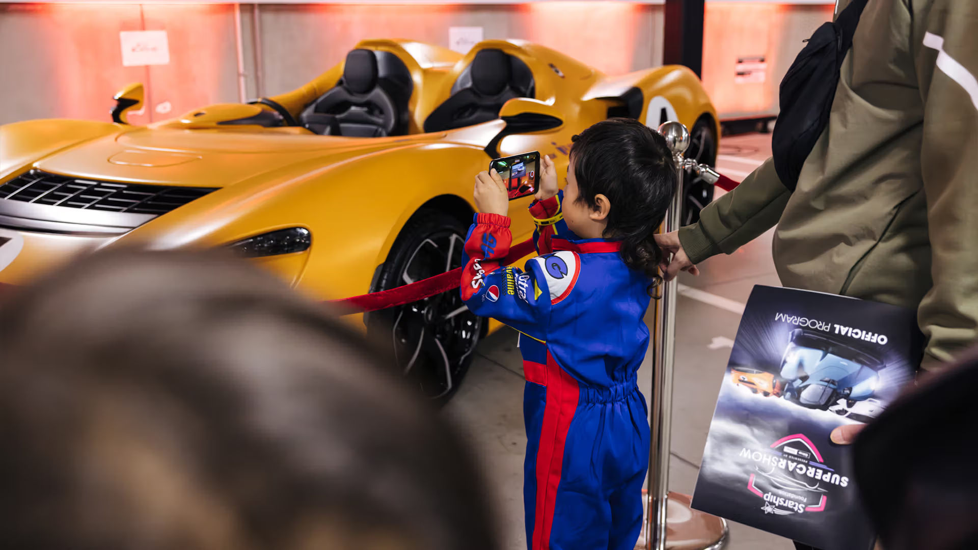 Child photographing a supercar at the Starship Supercar Show