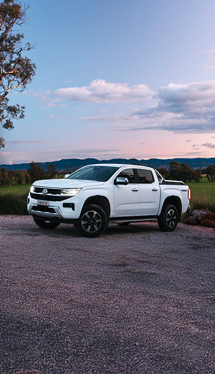 White Amarok Style parked on gravel
