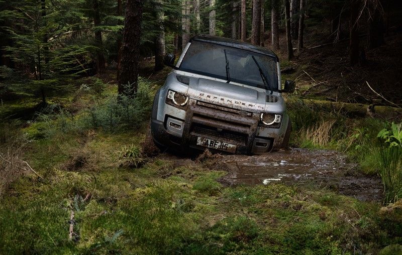 Defender driving through thick mud road