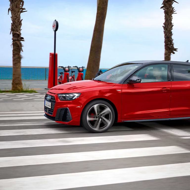 Audi A1 driving along water front
