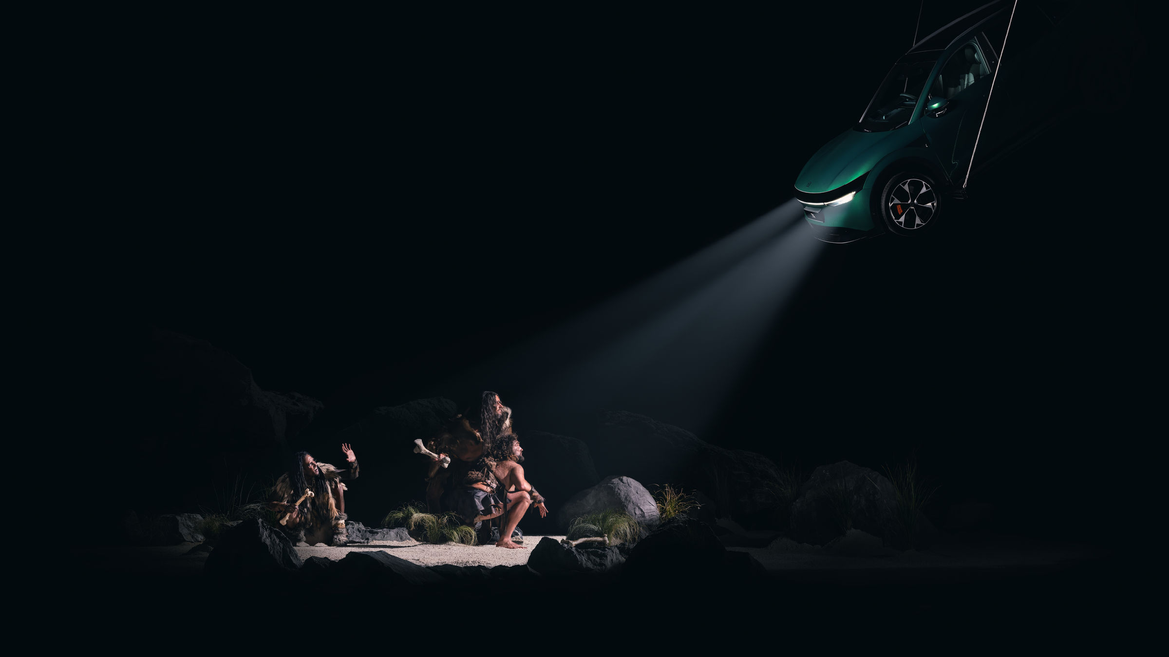 Caveman — one of seven scenes built and photographed by hand for the ZEEKR and Taika Waititi Spotlight exhibition, lit by a suspended ZEEKR 7X.
