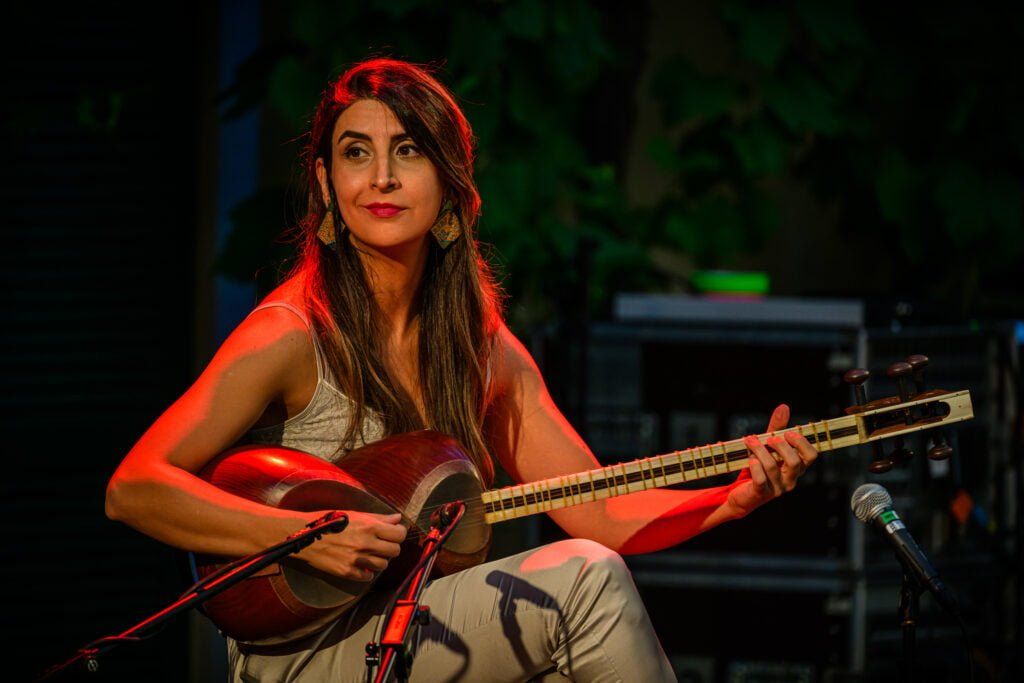 Portrait d'un membre du groupe Atine qui joue de la guitare