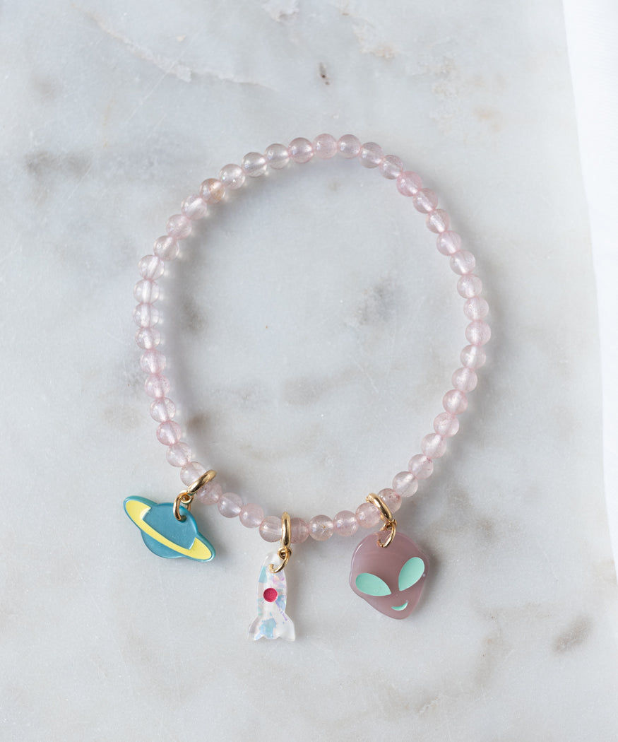 A WALD Berlin From Another Mother Rosé Orbit Bracelet with alien charms on it.