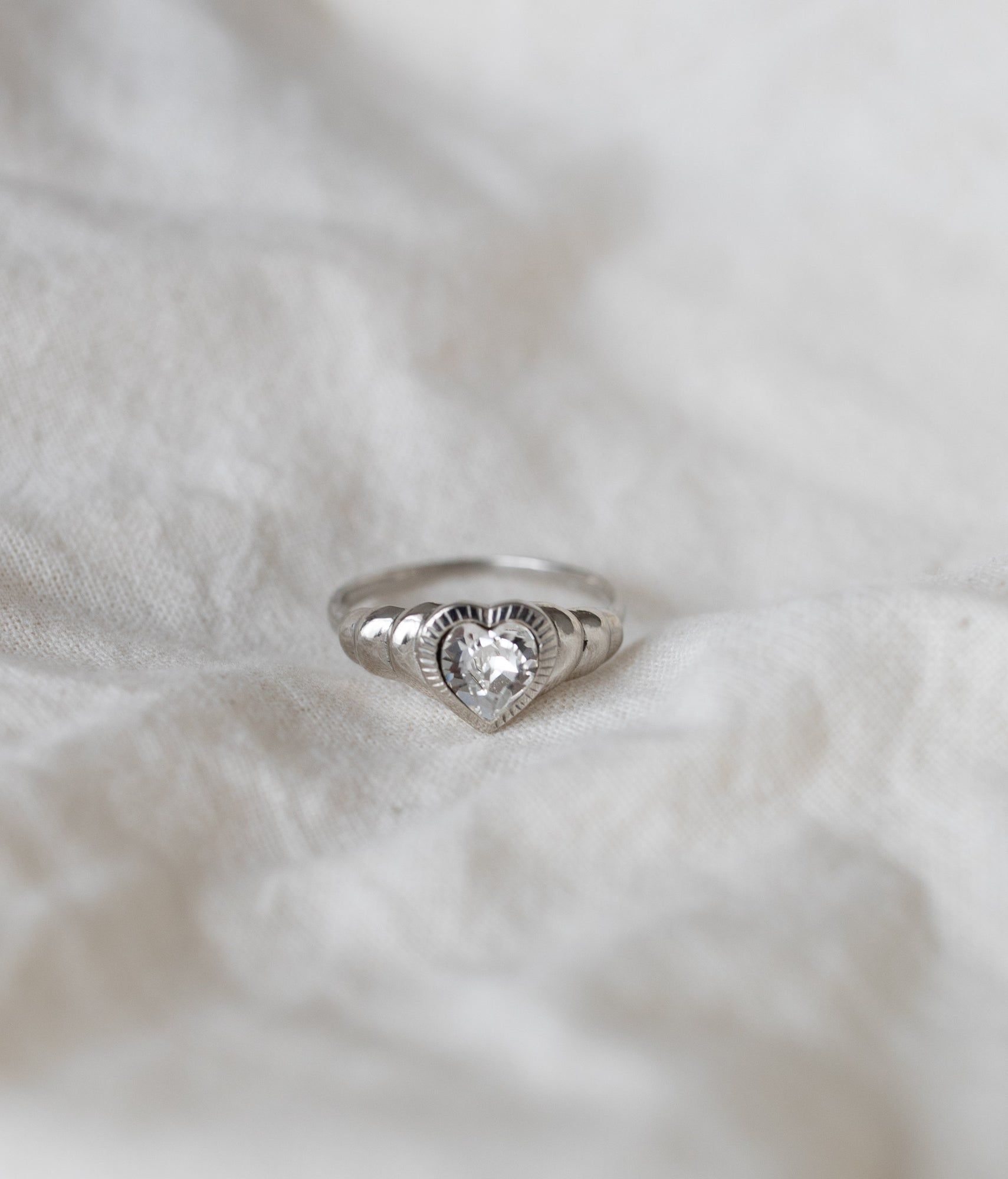 Be My Lover Mini Silver Ring by WALD Berlin on a textured white fabric background.