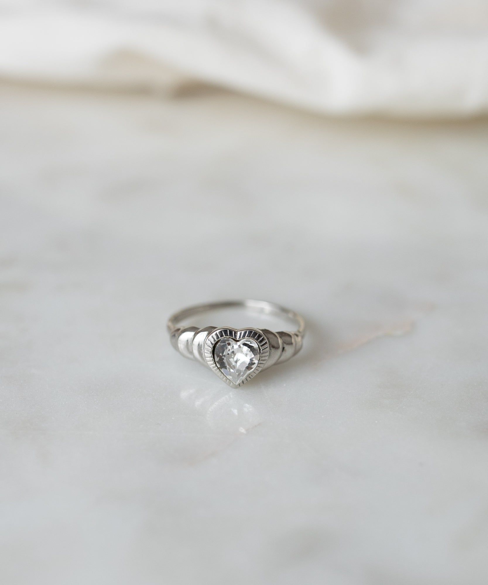 WALD Berlin's Be My Lover Mini Silver Ring on a marble surface.