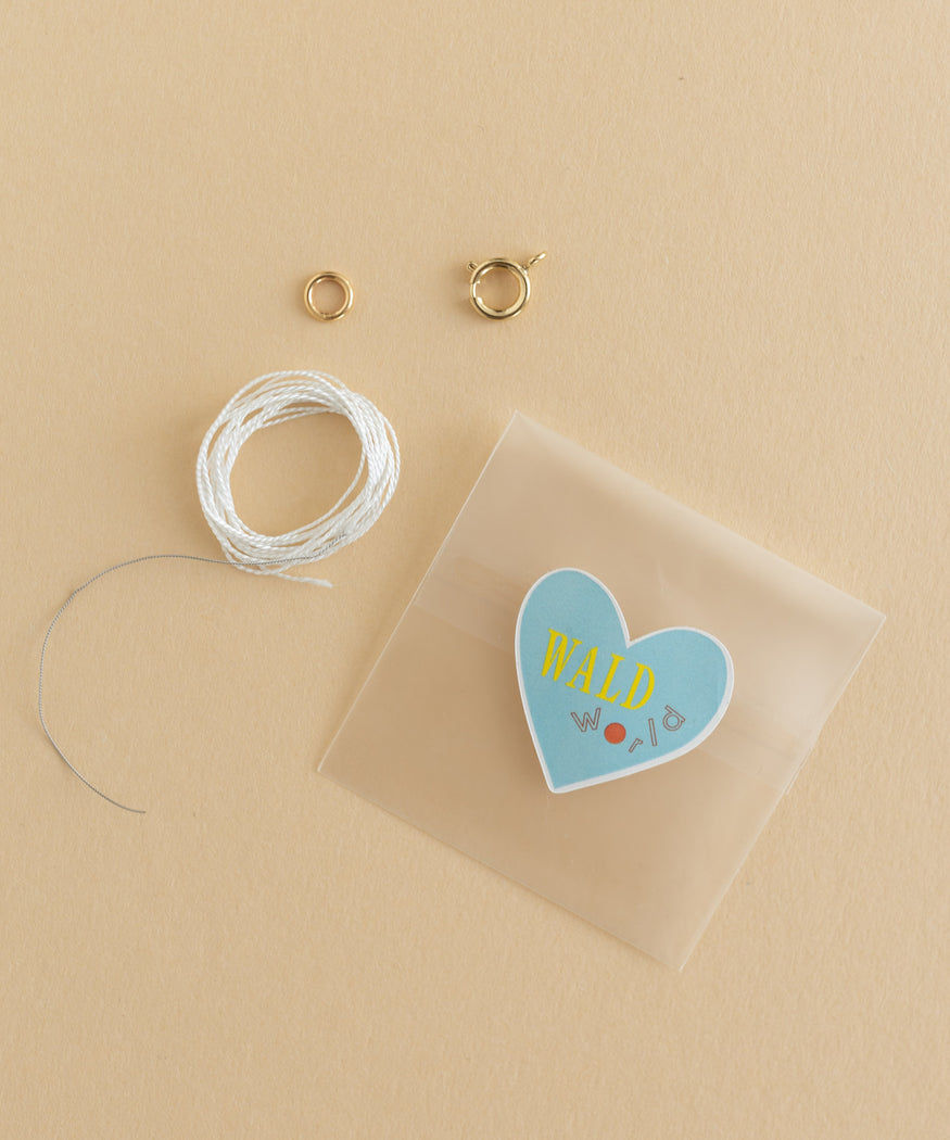 A jewelry kit featuring a WALD World Necklace and Bracelet Crafting Kit with wires.