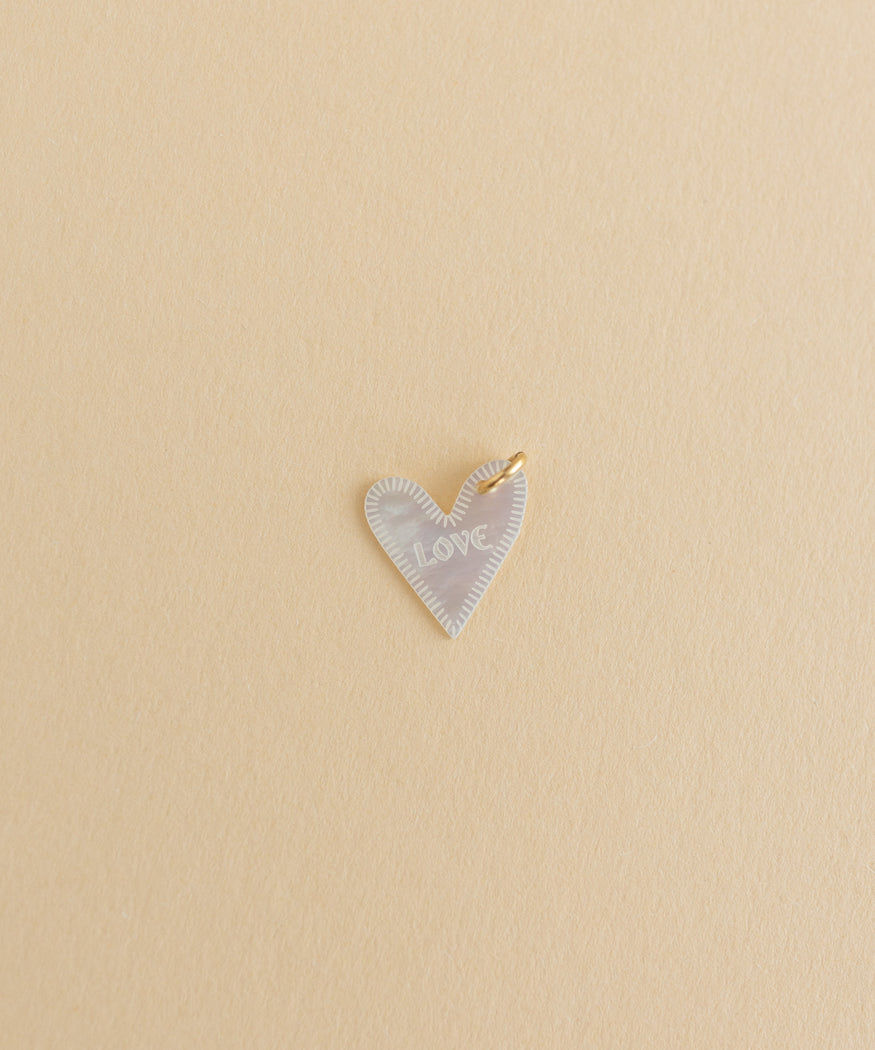 A small charm on a beige background by WALD World.