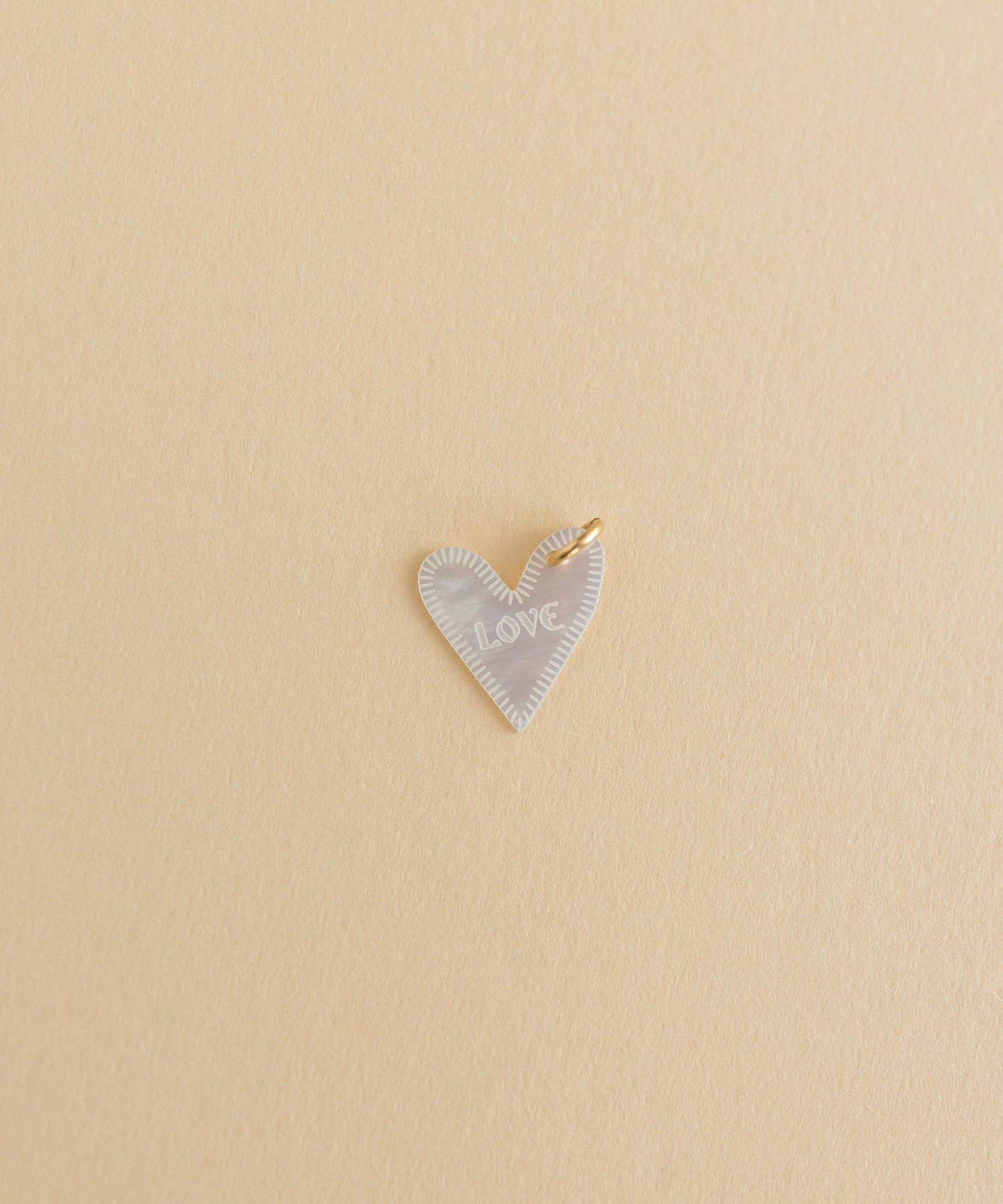 A small charm on a beige background by WALD World.