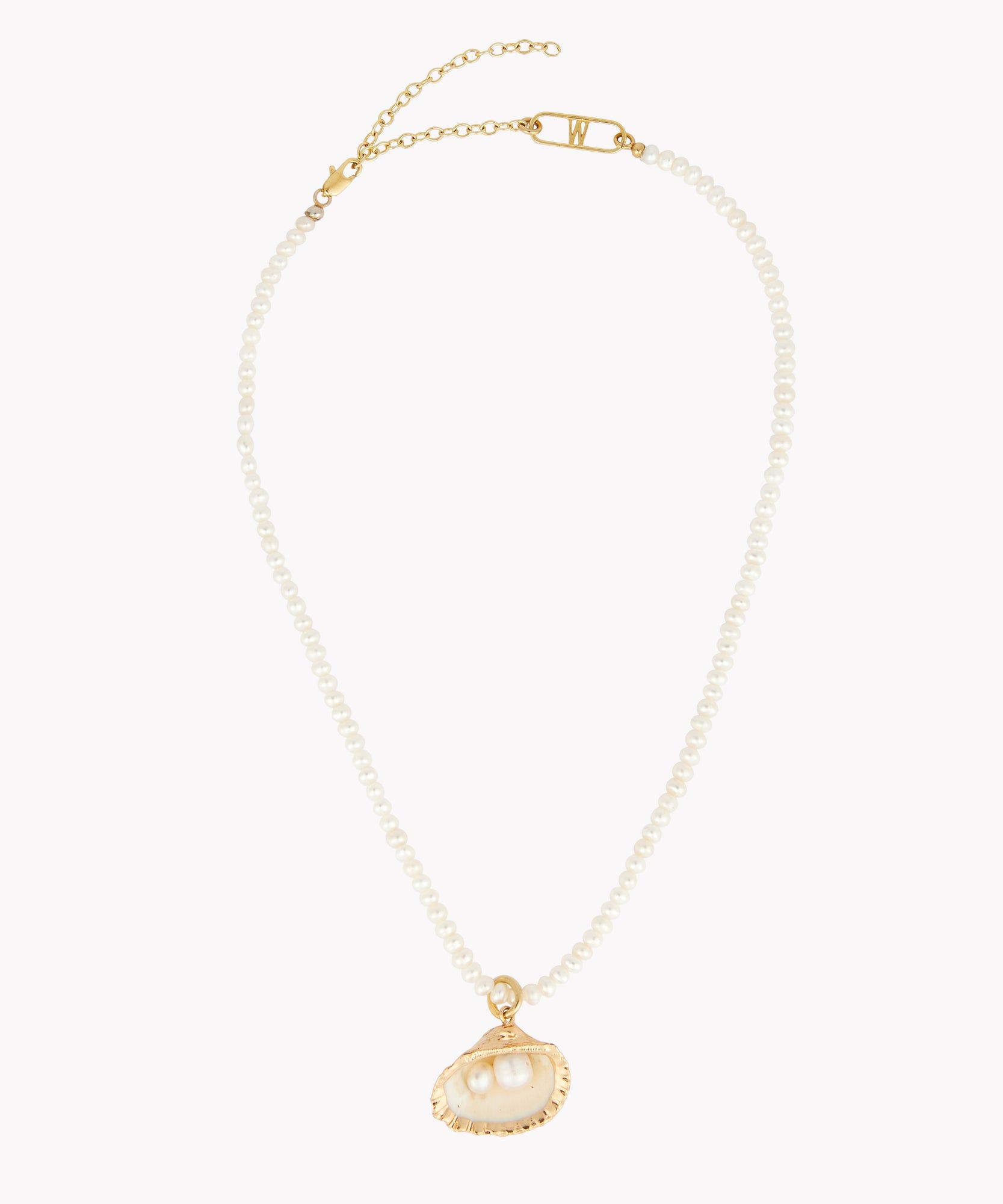 A Fairtrade La Piscina Drop It Like Its Hot Pearl Necklace by WALD Berlin with a gold chain and clasp, featuring a seashell pendant adorned with two stunning pearls.