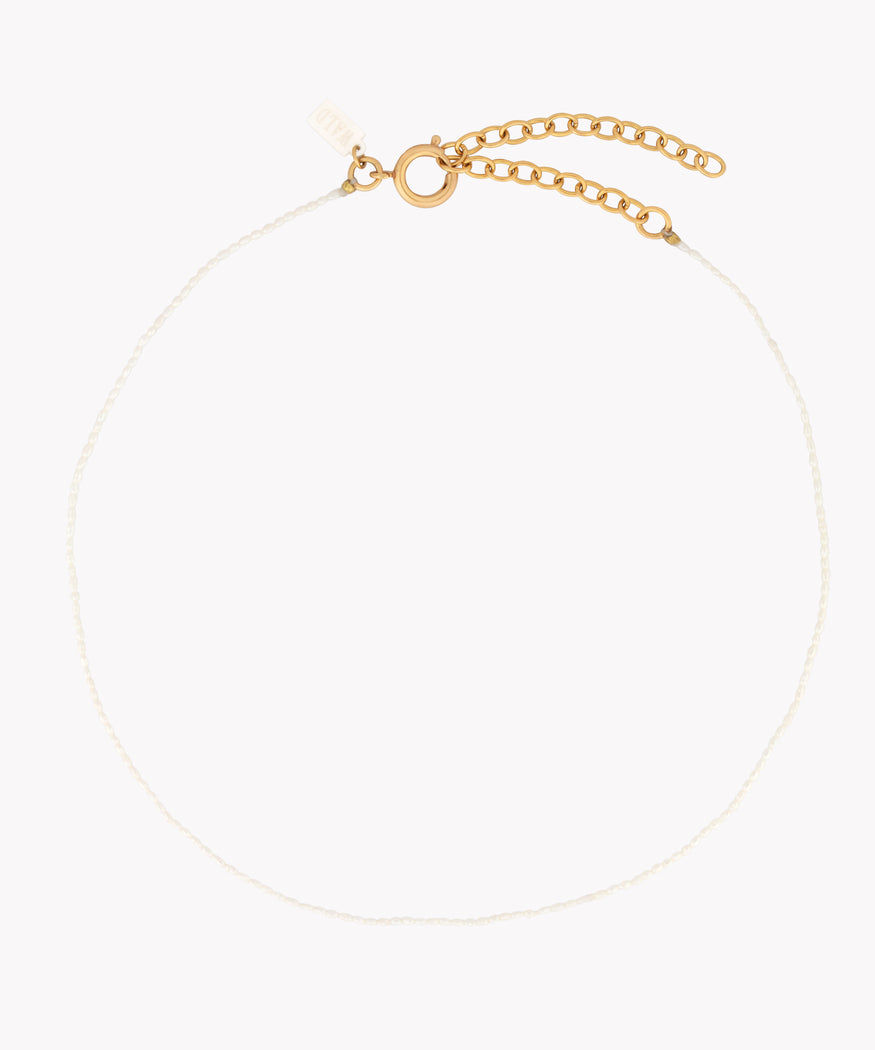 A fine jewelry necklace from WALD Berlin on a white background.
