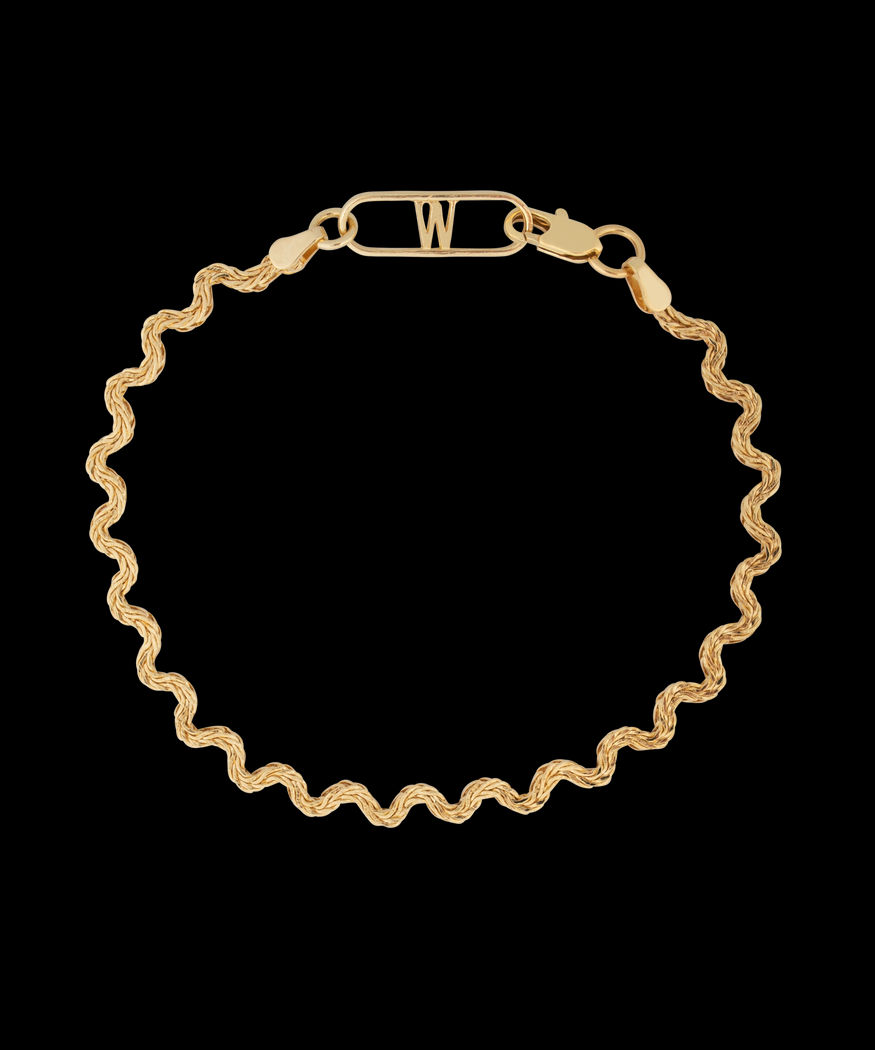 A WALD Berlin Irina Gold Bracelet with a curved clasp made of brass.