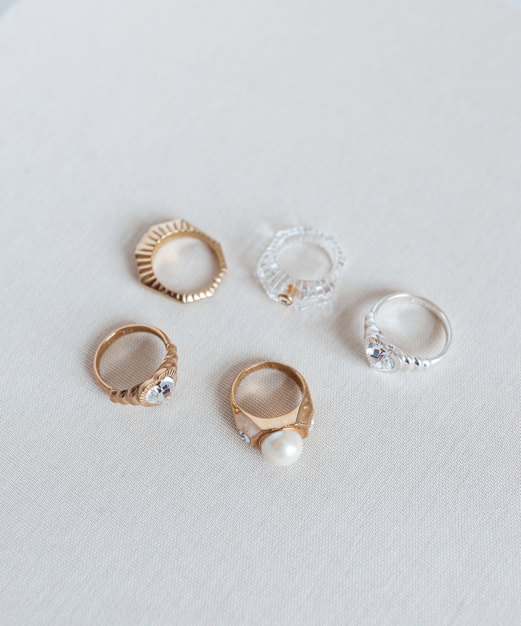 A collection of Berlin-made jewelry, featuring Shining Star Crystal Rings, displayed on a white surface.