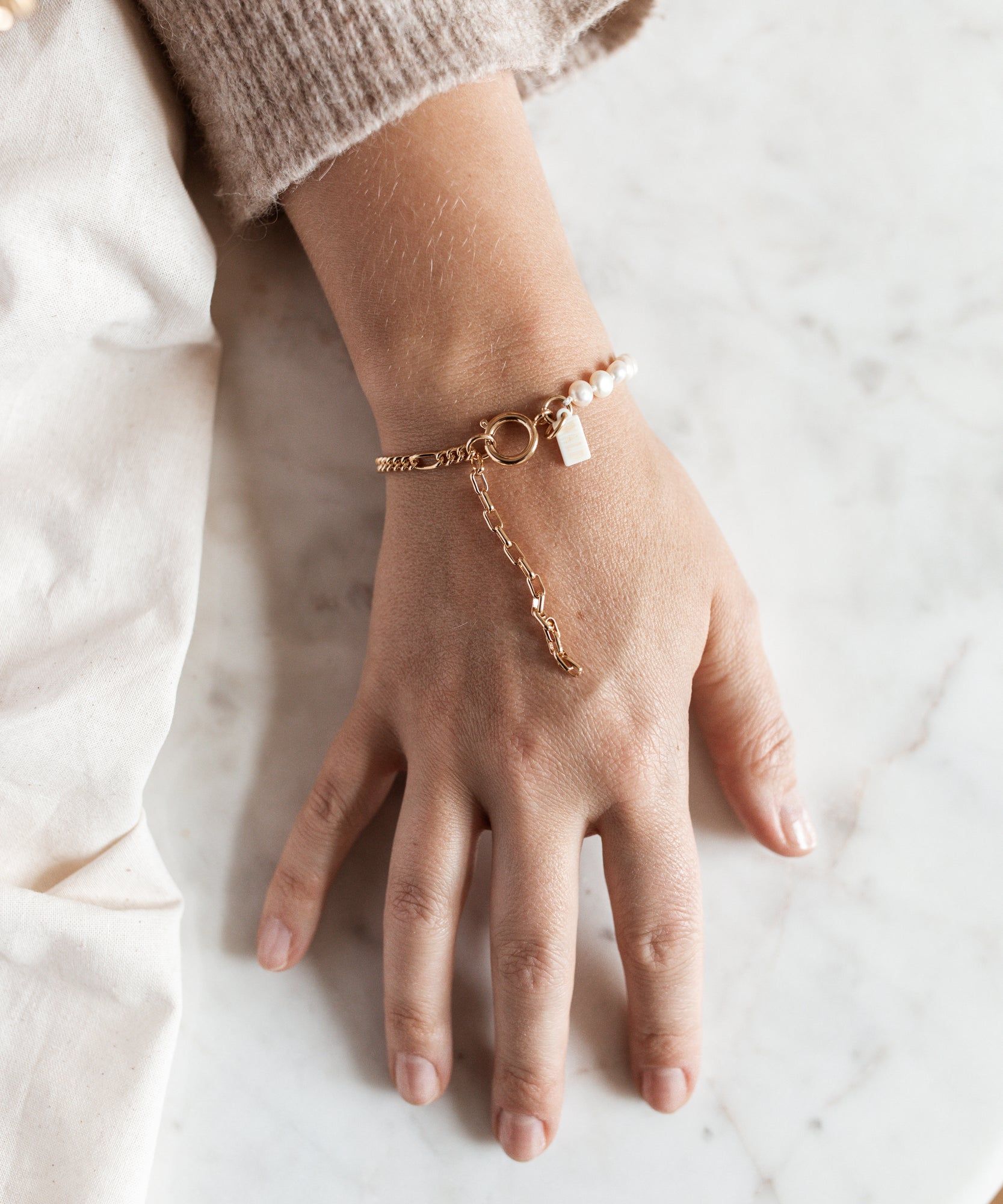 A woman's hand adorned with a stunning WALD Berlin Pas De Deux bracelet, carefully crafted by hand.