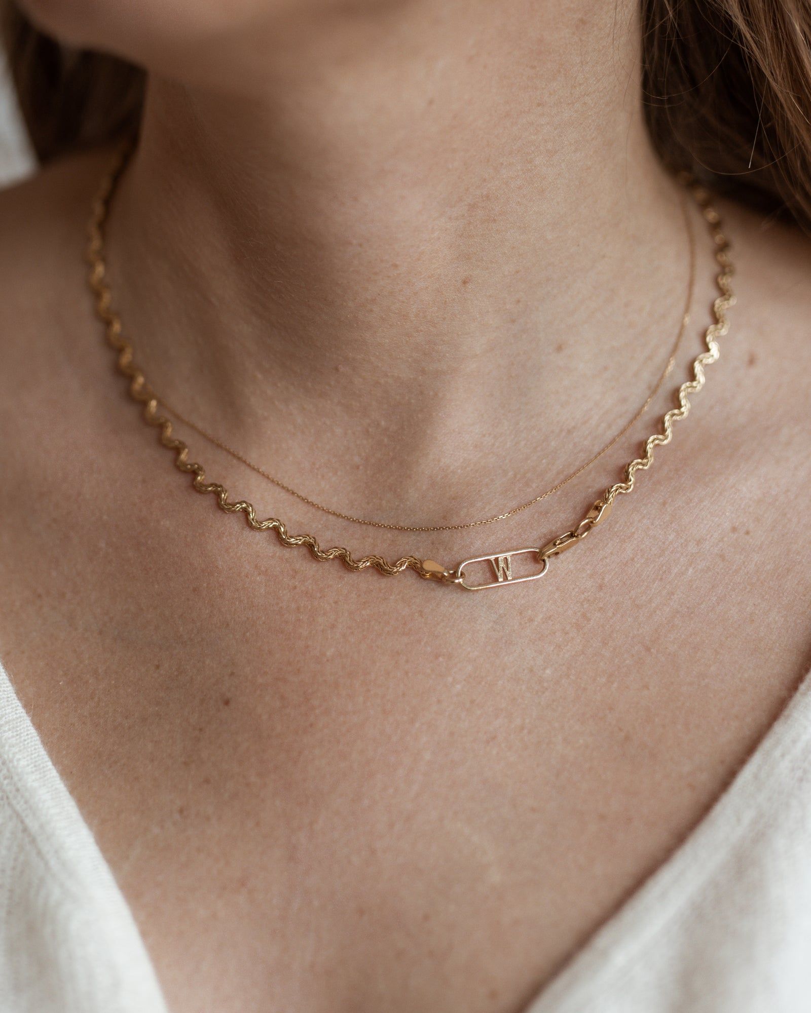 A woman's neck adorned with jewelry from Berlin, Germany - the Wald Berlin Irina Necklace Gold.