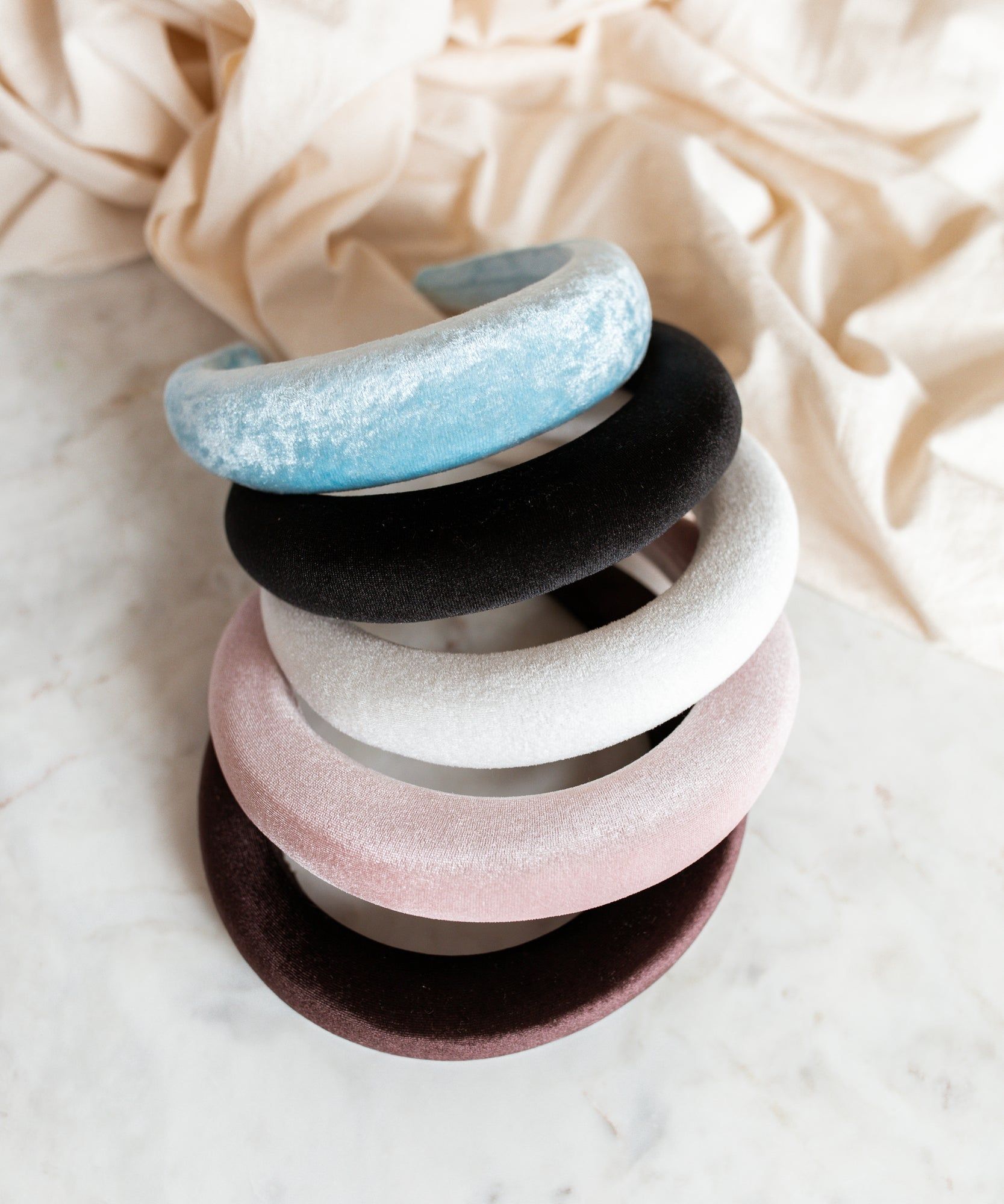 A set of four WALD Berlin Black Velvet Headbands showcasing German style jewelry on a white surface.