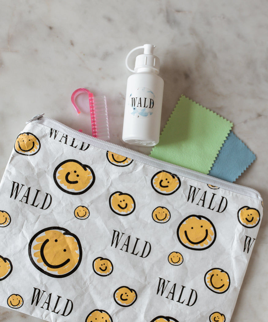 A yellow WALD Berlin Cleaning Set with a smiley face on it, perfect for jewelry cleaning.