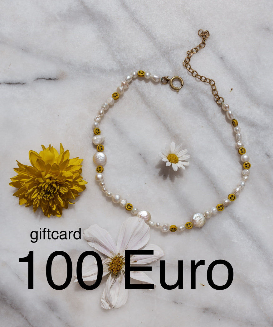 A Berlin-made necklace featuring delicate flowers accompanied by a €100 gift card for WALD Berlin jewelry.