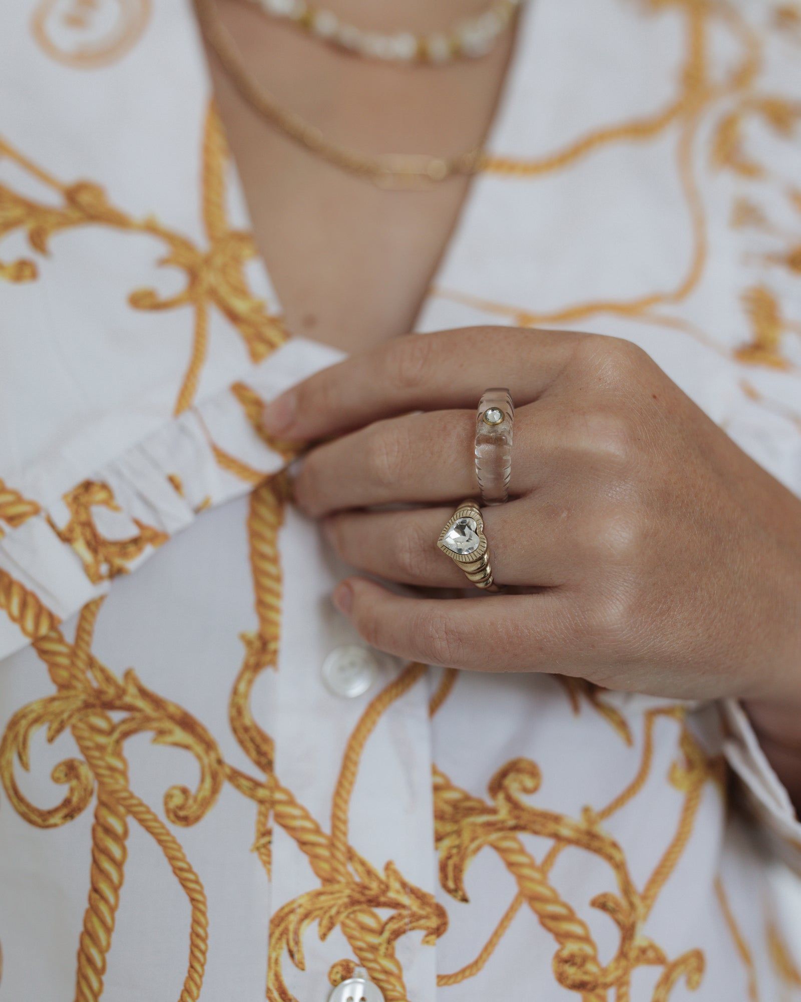 A woman adorned in german jewelry, including the Shining Star Crystal Ring, from WALD Berlin.